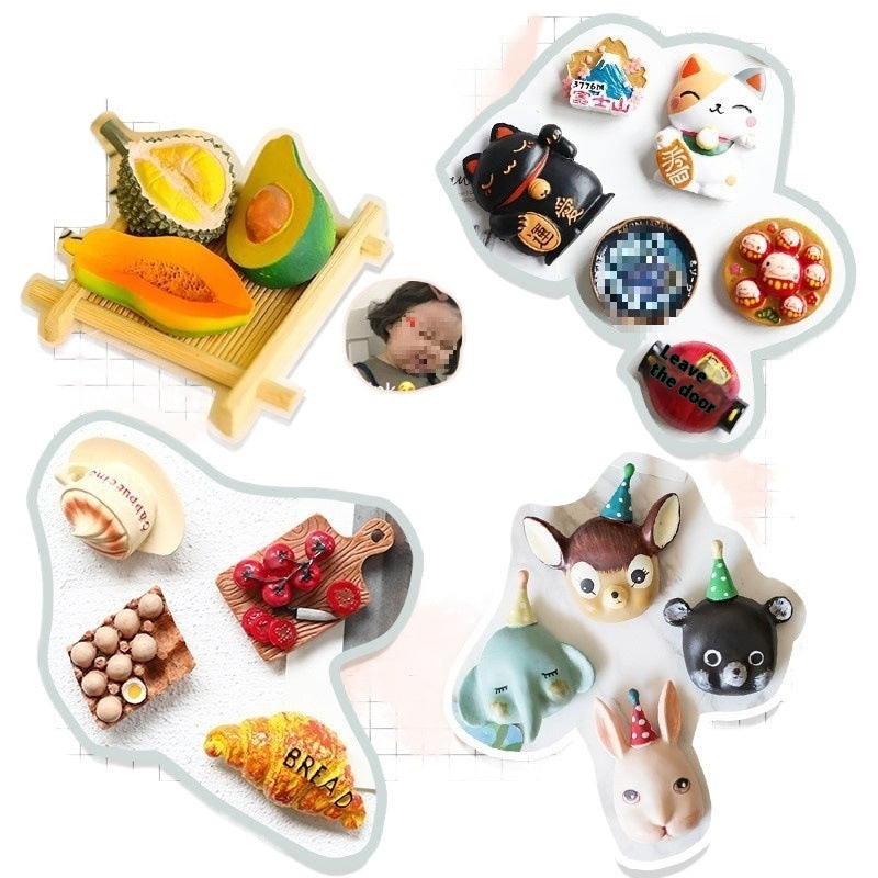 Collection of various small figurines including fruits, animals, and other items on a white background.