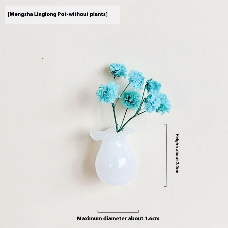 White vase with blue flowers on a beige background