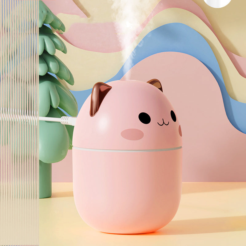 Pink cat-shaped humidifier with a cute face on a colorful background
