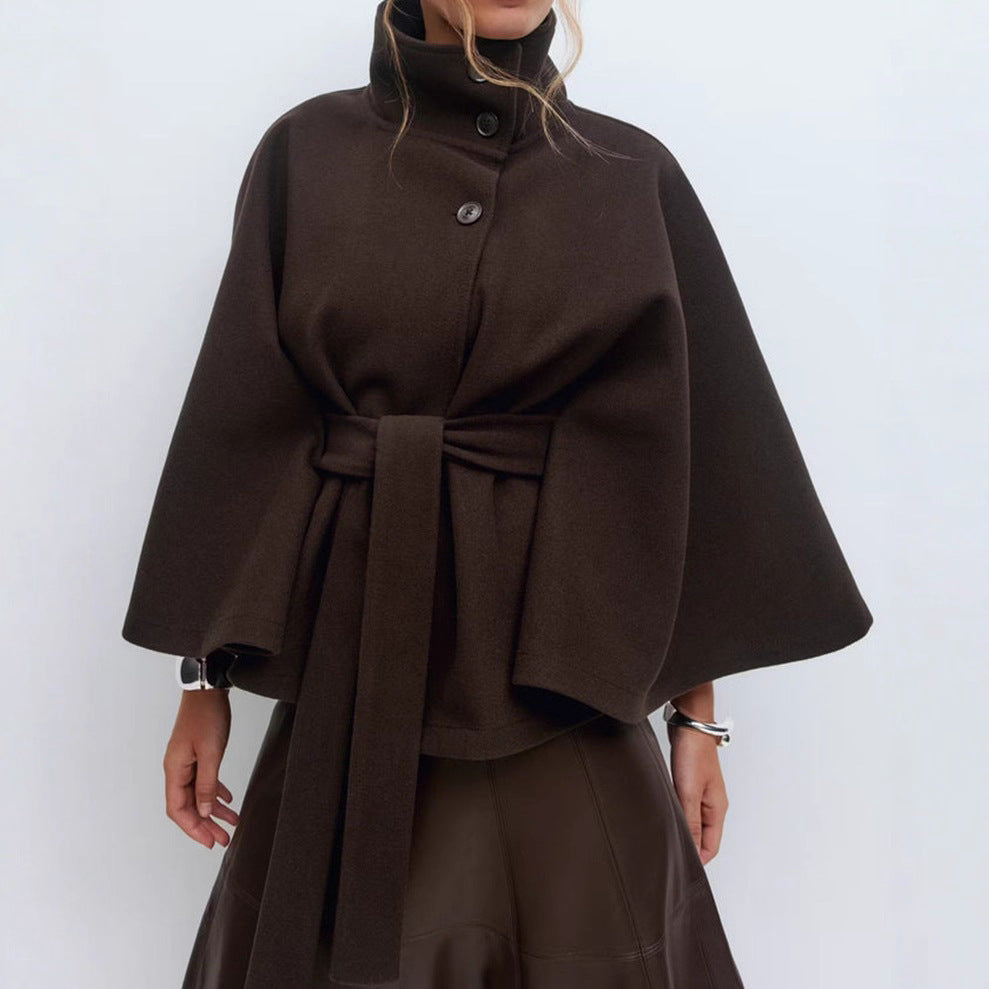 Brown cape coat worn by a person on a white background