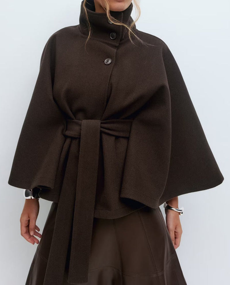 Brown cape worn by a person on a white background