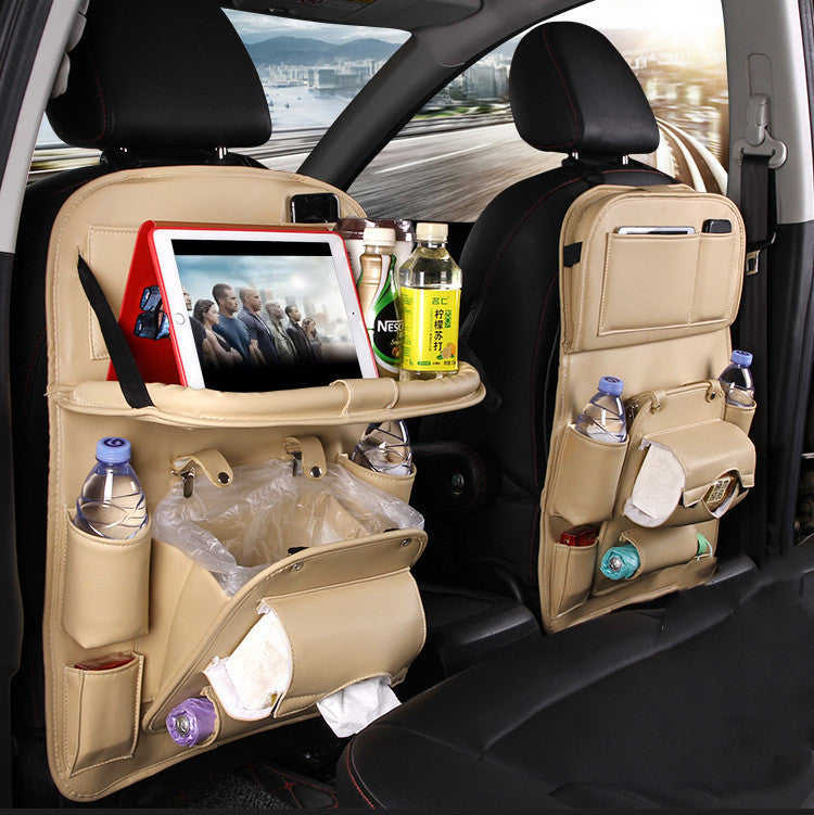 Car back seat organizer with various items in a vehicle interior.