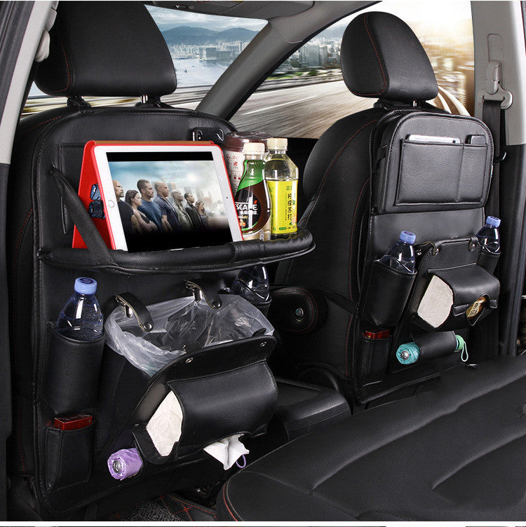 Car interior with a tablet holder, drink holders, and snacks on a cityscape background