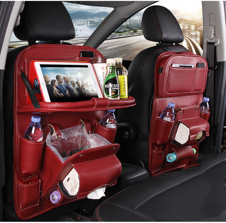 Red car seat organizer with multiple pockets and a tablet holder, placed inside a vehicle.