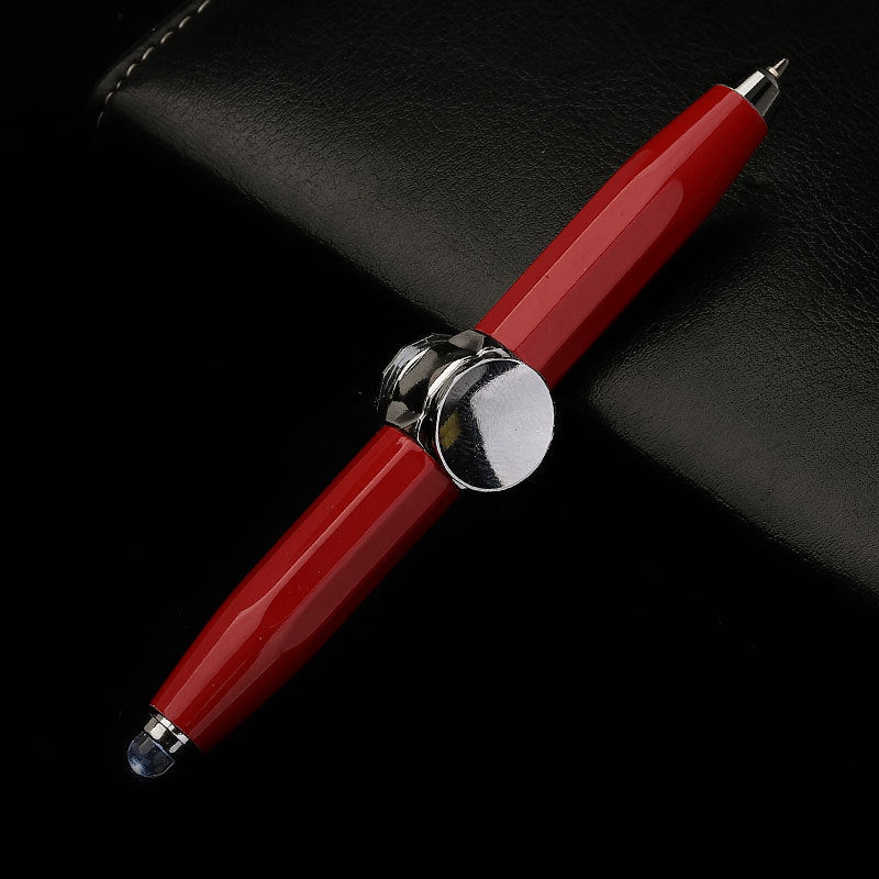 Red pen with silver accents on a black background