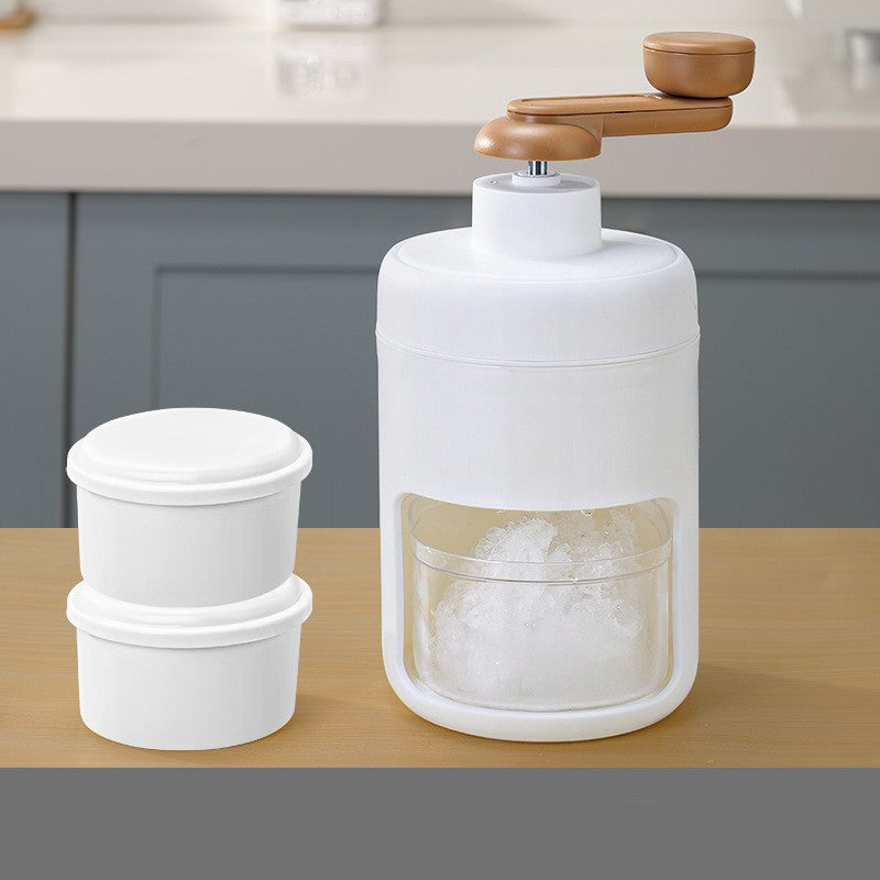 A person holding a bowl of cereal topped with fruits next to a white hand block shaving machine and a small white ice maker.