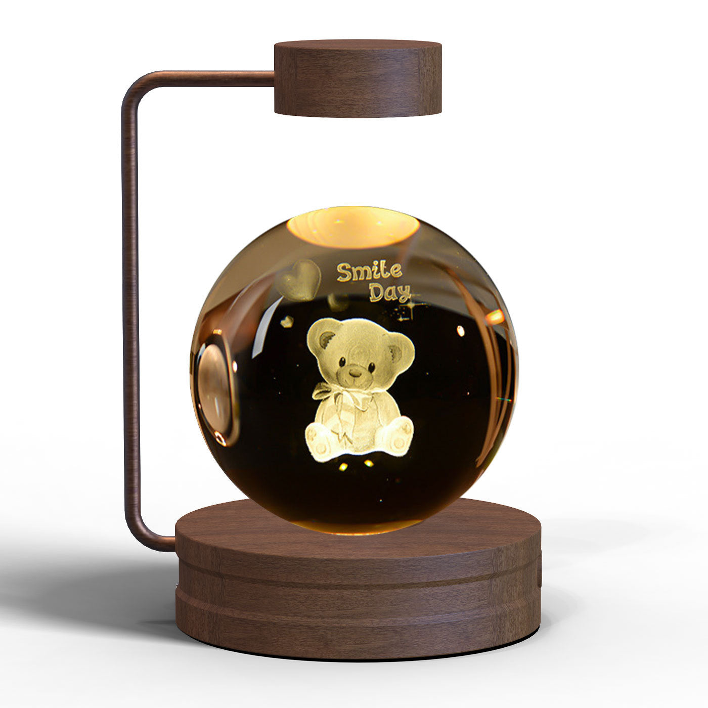Glowing ball with a teddy bear inside, featuring the text 'Smile Day', on a wooden stand.