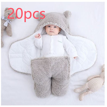 Baby in a gray outfit with bear ears surrounded by plush toys on a white background