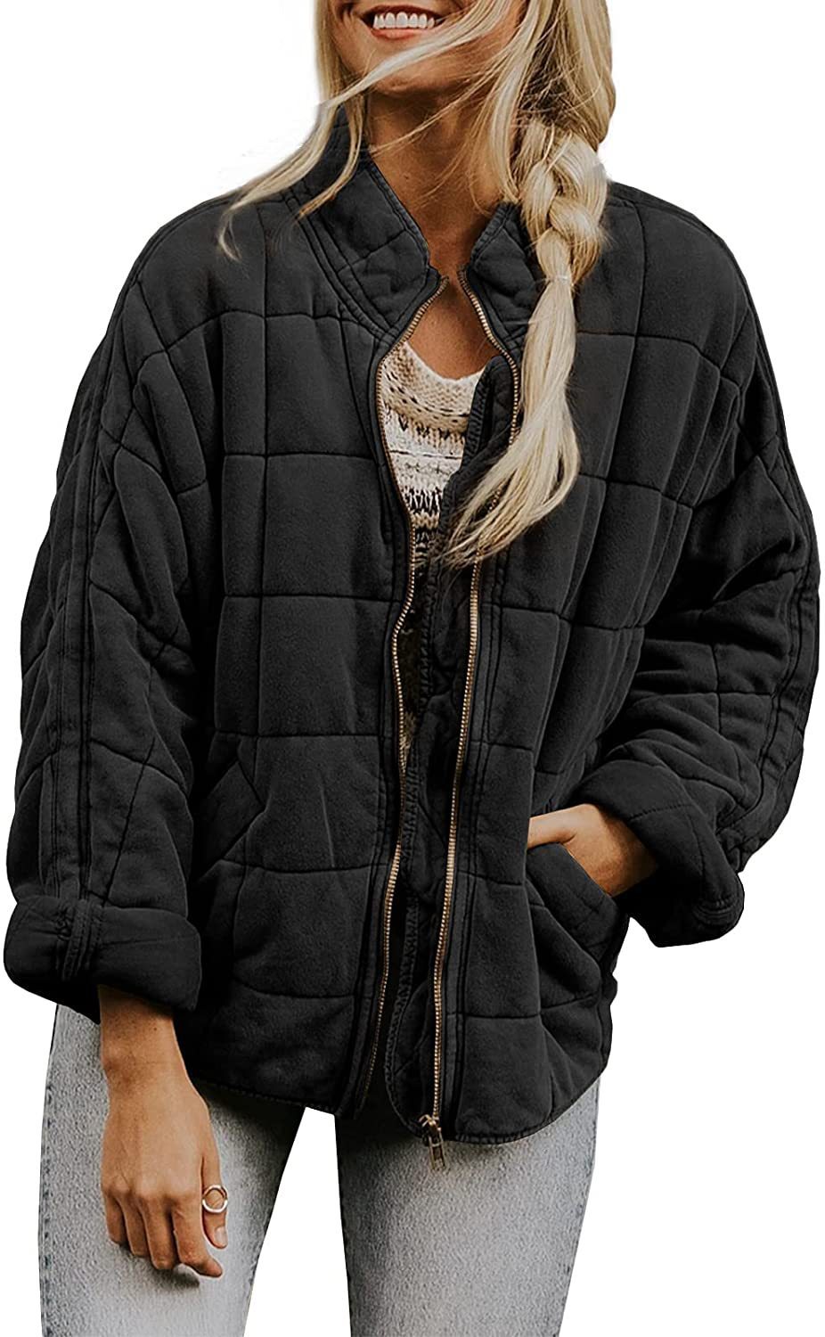 Woman wearing a black quilted jacket on a white background