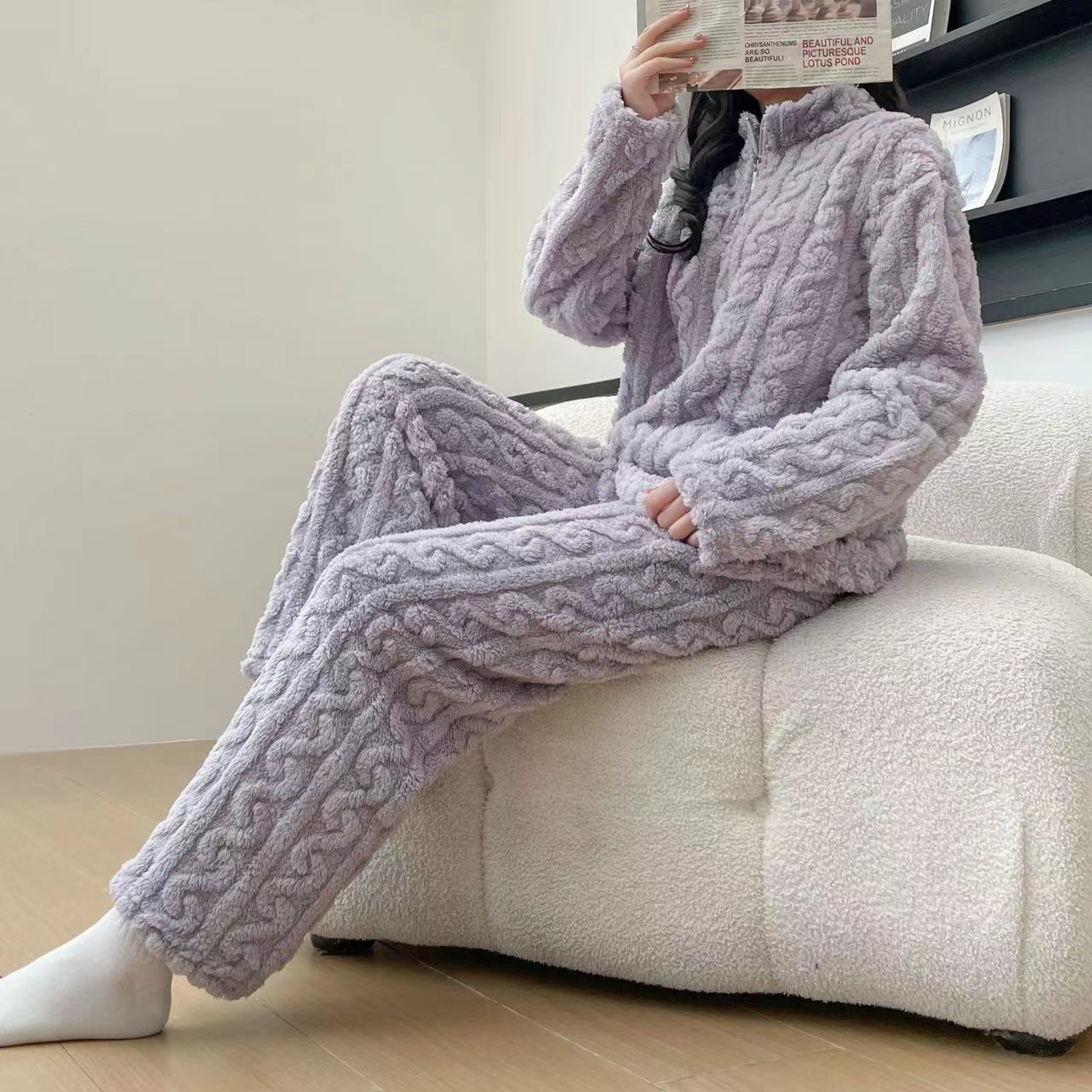 Person wearing a purple cable-knit loungewear set sitting on a white chair.