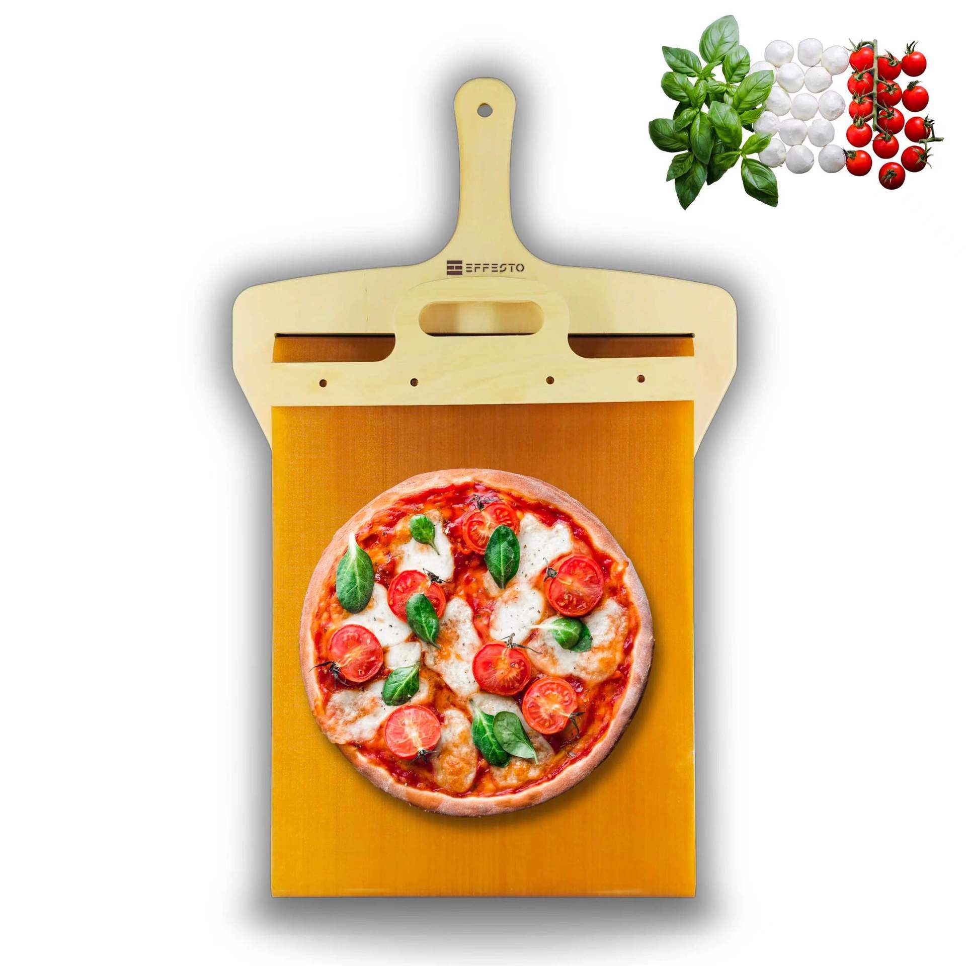 Wooden pizza peel with a pizza on a white background, accompanied by basil leaves and cherry tomatoes.