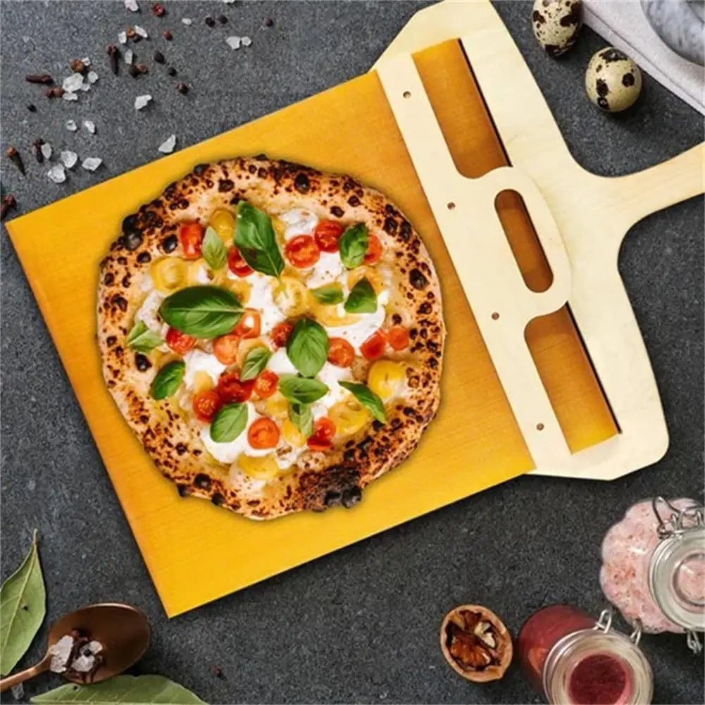Pizza on a yellow stone with a pizza peel, surrounded by ingredients on a dark surface.