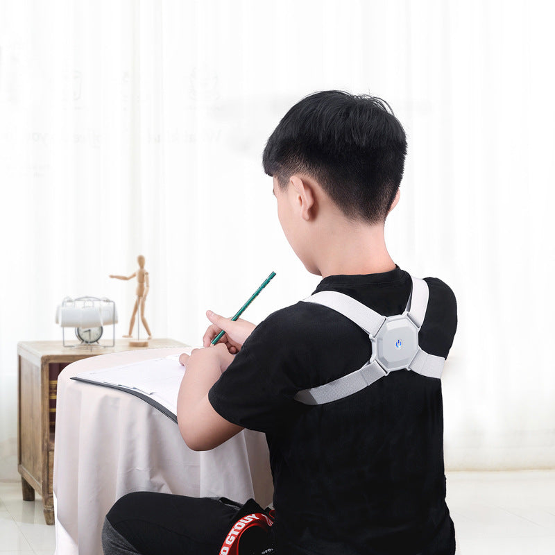 Person wearing a posture corrector while sitting at a desk.