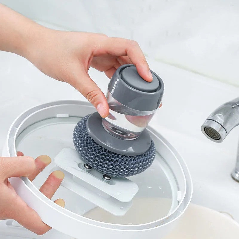 Person holding a gray and clear cleaning tool over a sink