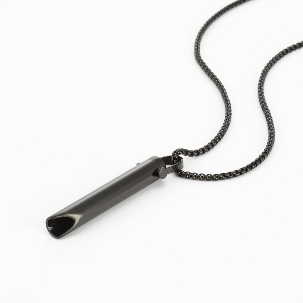 Black metal whistle pendant on a chain against a white background