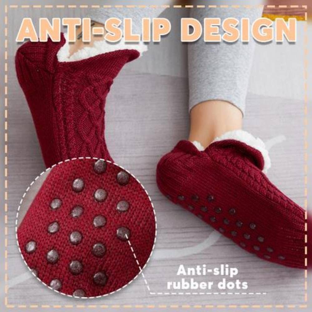 Red slipper socks with anti-slip rubber dots on a gray background