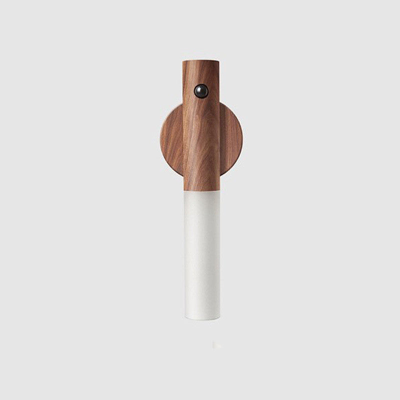 Wooden and white pepper grinder on a light gray background