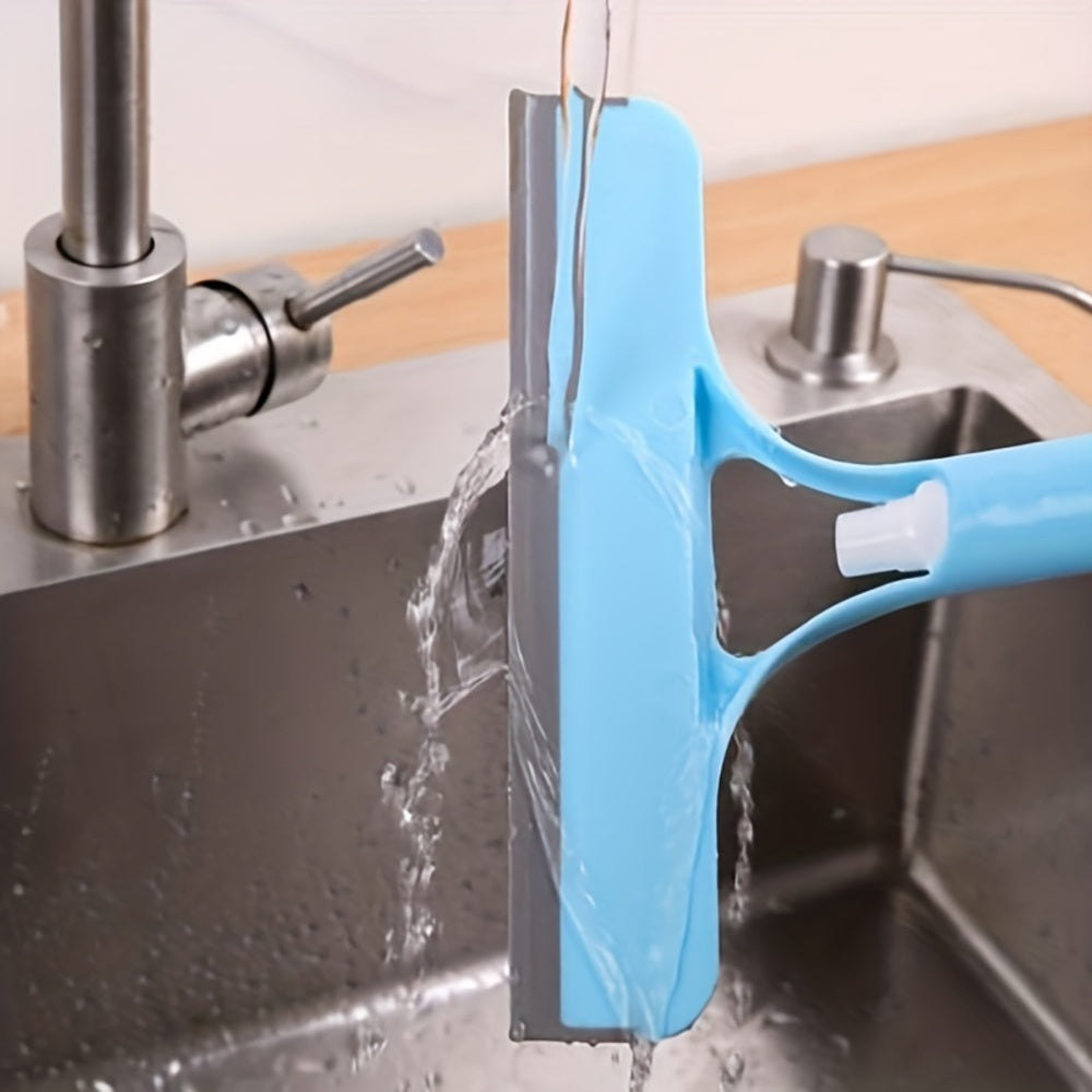 Blue cleaning tool being rinsed under running water in a kitchen sink.